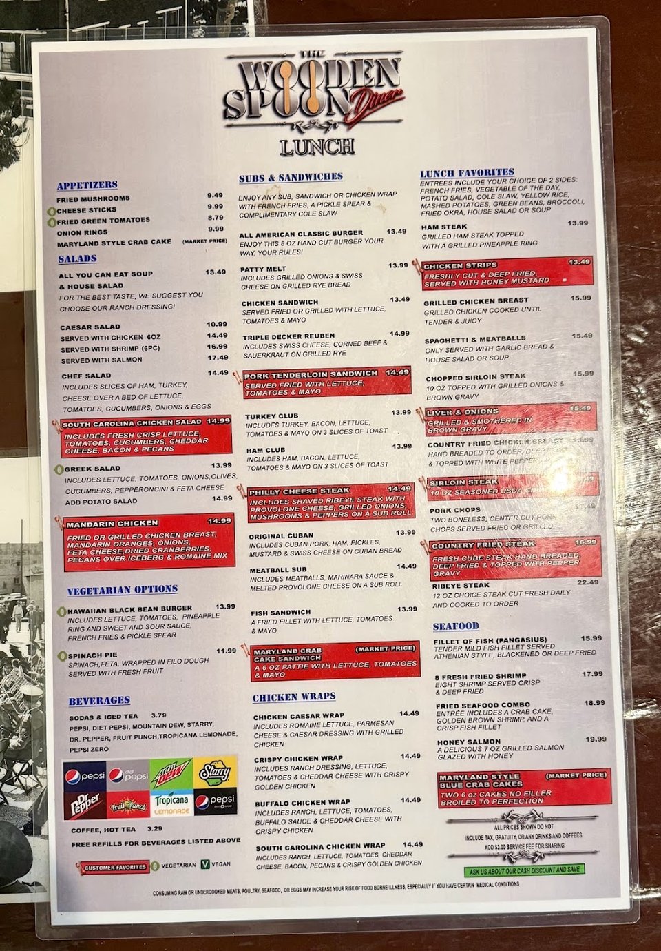 Printed menu with sandwiches, salads, and burgers.